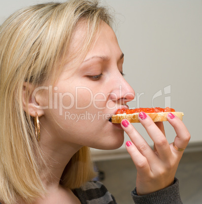 Girl with an open sandwich.