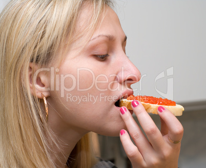 Girl with an open sandwich.