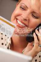 Beautiful Woman on Phone Holding Credit Card