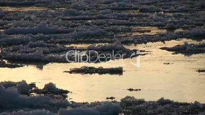 Ice drift in a river at sunset 11