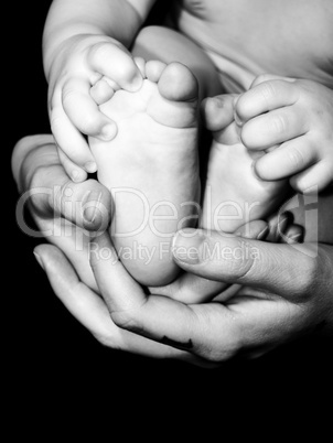 Baby feet and mother's hands