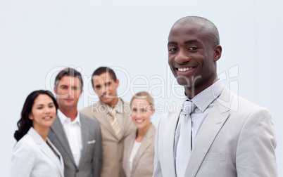 Smiling Afro-American businessman in front of his team