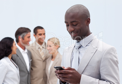 Attractive Afro-American businessman writing a message