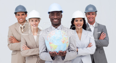 Architectural team holding a terrestrial globe