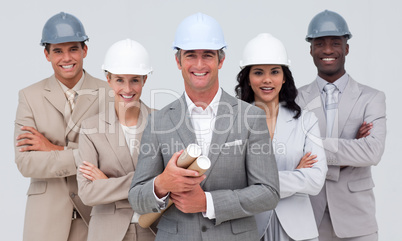 Architectural team smiling at the camera with hard hats
