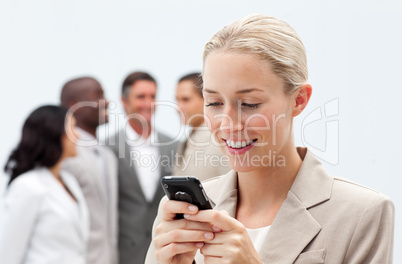 Smiling businesswoman sending a text