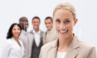 Portrait of smiling businesswoman in front of her team
