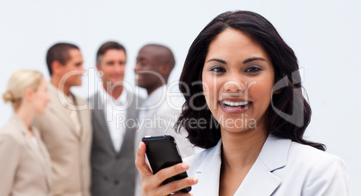 Smiling ethnic businesswoman texting with a mobile phone