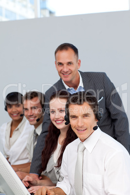 Manager and his team working in a call center