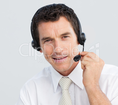 Portrait of an attractive businessman working in a call center