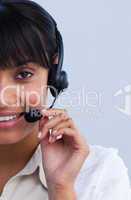 Close-up of smiling ethnic businesswoman working in a call cente