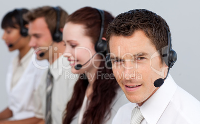Attractive man working with his team in a call center