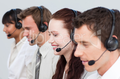 Beautiful woman working with other people in a call center