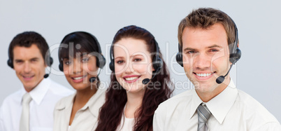Smiling team working in a call center