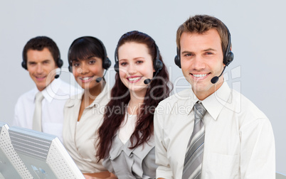 Smiling people with a headset on working in a call center