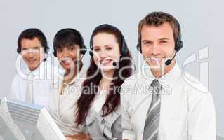 Smiling people with a headset on working in a call center