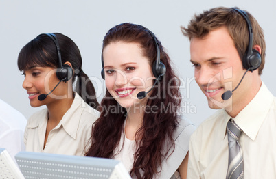 Beautiful woman working with her team in a call center