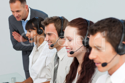 Manager talking to his team in a call center