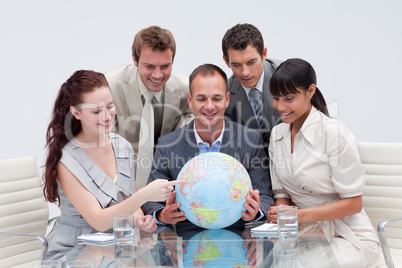 Business team holding a terrestrial globe. International busines