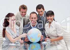 Business team holding a terrestrial globe. Worldwide business