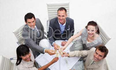 Group of architects celebrating a success in the office