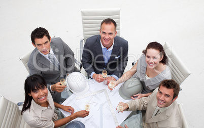Group of architects drinking champagne in the office
