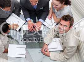 High angle of businessman working with his colleagues