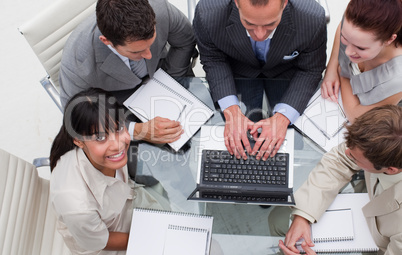 High angle of smiling businesswoman working with her team