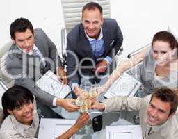 High angle of business team celebrating a success with champagne