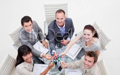 High angle of smiling business team holding molecules
