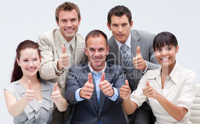 Happy business team with thumbs up