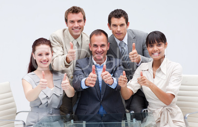 Confident business team with thumbs up