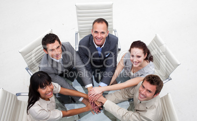Smiling business team with hands together