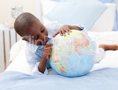 Small boy looking at a Globe