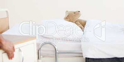 Teddy bear alone in a hospital bed