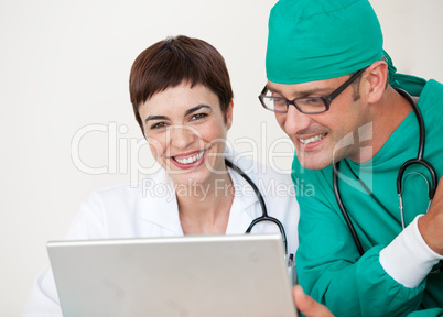 Doctor and surgeon looking at a laptop