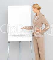 Businesswoman Standing  pointing at a whiteboard