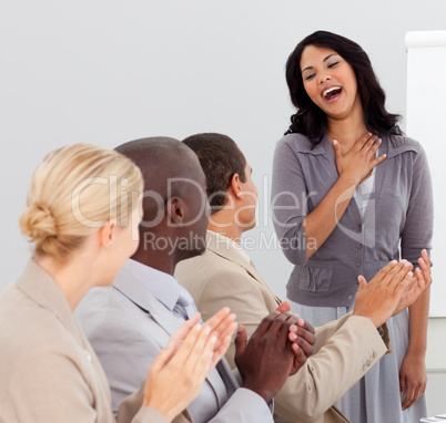 Business people clapping at a presentation