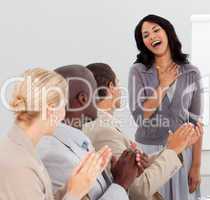 Business people clapping at a presentation
