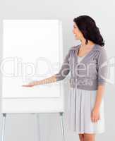 Business woman smiling and pointing at presentation Board
