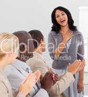 Business people clapping at a presentation