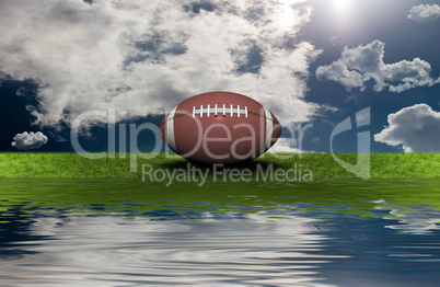 football on the green grass with sky background