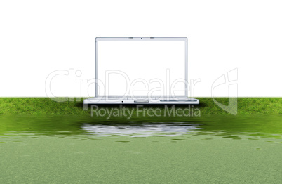 blank laptop computer on the green grass