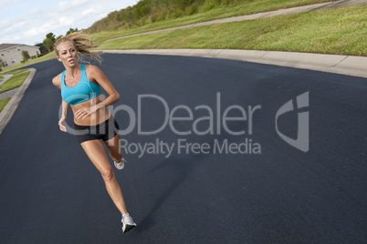 Beautiful Blond Woman Running and Listening to MP3 Player