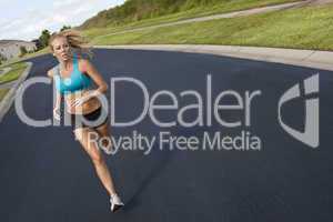 Beautiful Blond Woman Running and Listening to MP3 Player