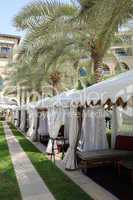 Luxurious  hotel recreation area with huts and palm trees, Dubai