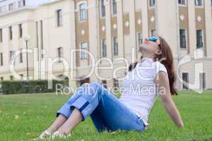 The nice girl having a rest on a grass