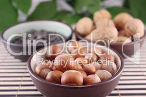 Wood nuts in cup on bamboo napkin