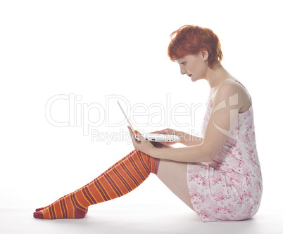 Red Girl in stripe socks  with laptop on white background