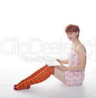 Red Girl in stripe socks  with laptop on white background